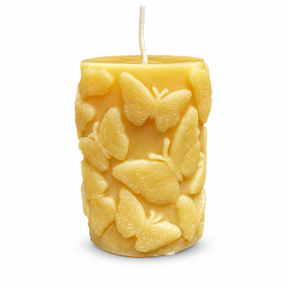 Butterfly-patterned beeswax pillar candle on a white background with a soft base shadow.