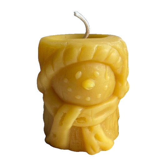 Snowman relief beeswax pillar candle with complete curved wick on white background
