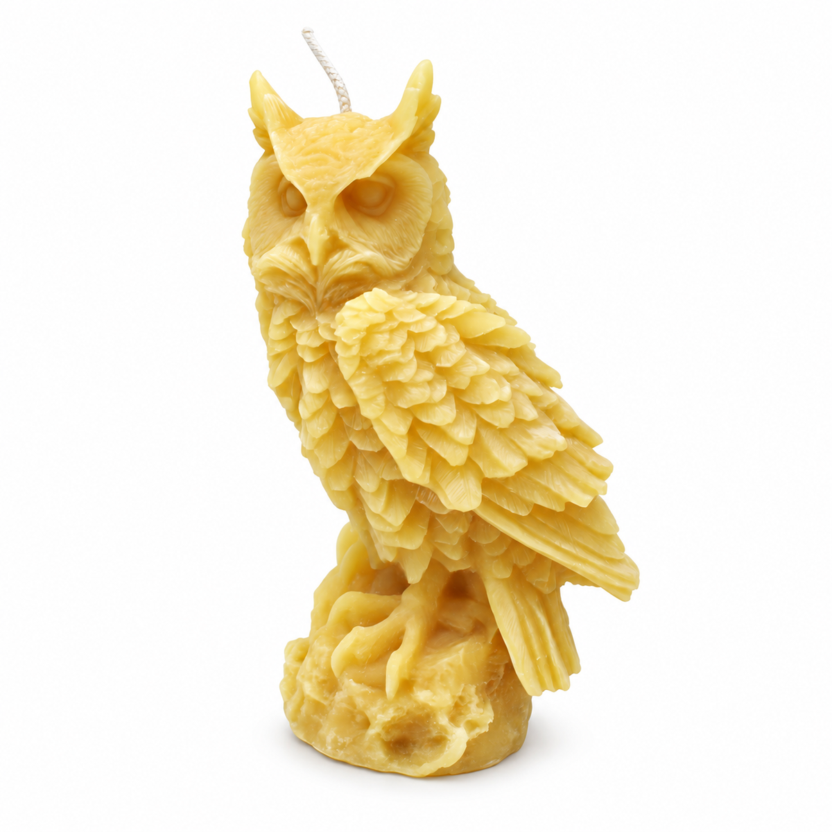 Large owl-shaped beeswax candle on a white background with a soft base shadow.