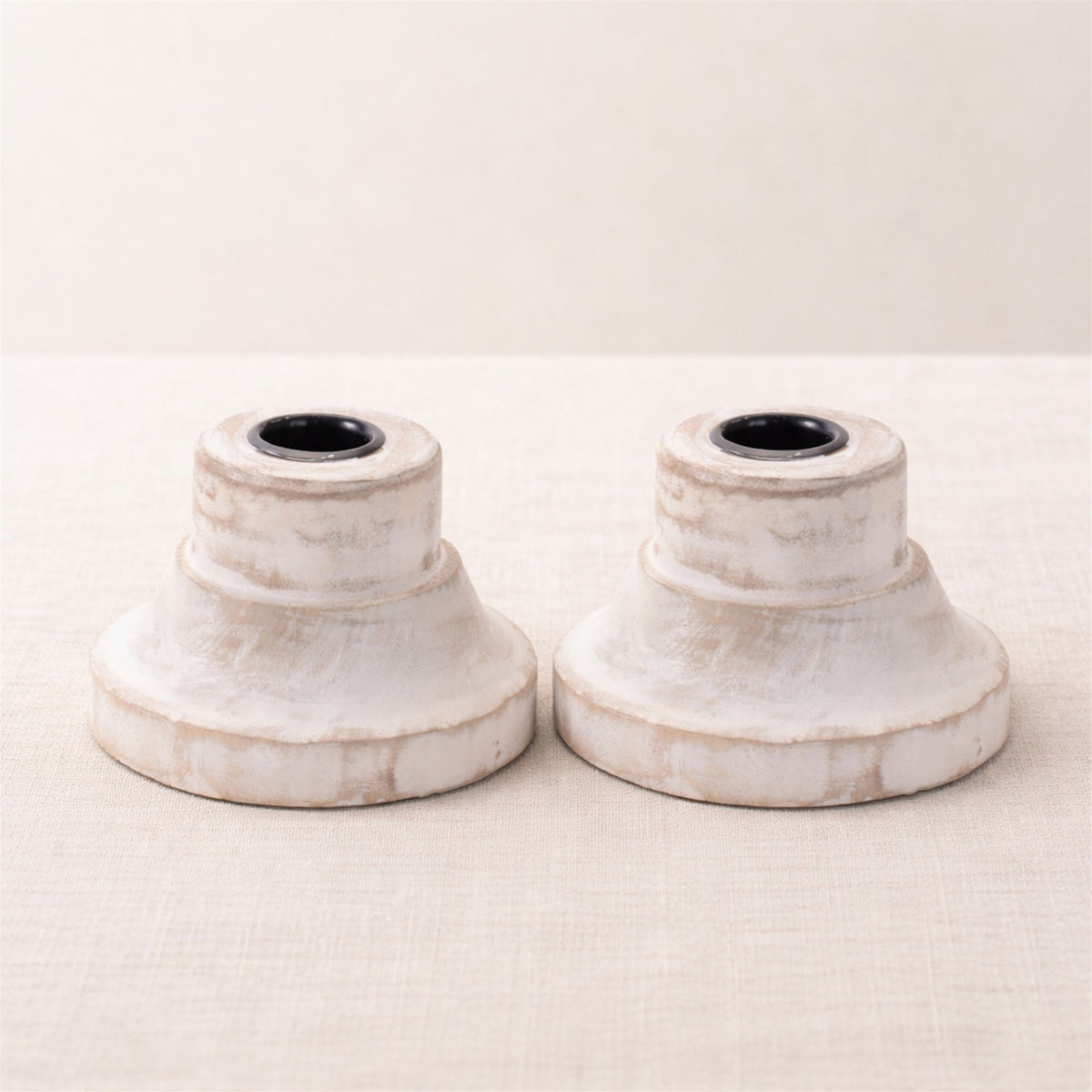 Two matching white washed wood taper candle holders; actual supplier photo