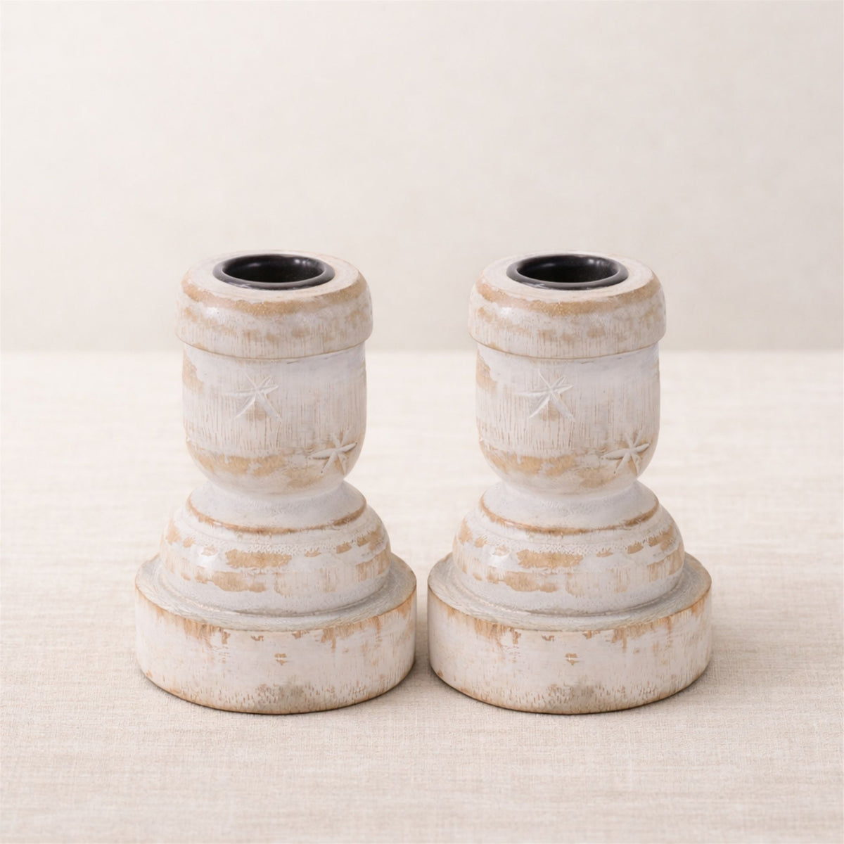 Two matching white washed wood taper candle holders; actual supplier photo